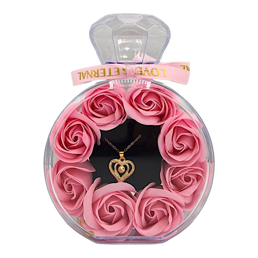 Geschenkbox in Parfümflaschen-Design mit rosa Seifenrosen und Herz Halskette